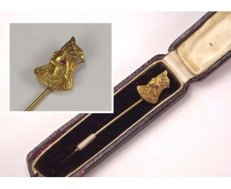 STICK PIN.
A 9ct. gold stick pin, in Etruscan Revival style, set a ruby & split pearls. Original case.