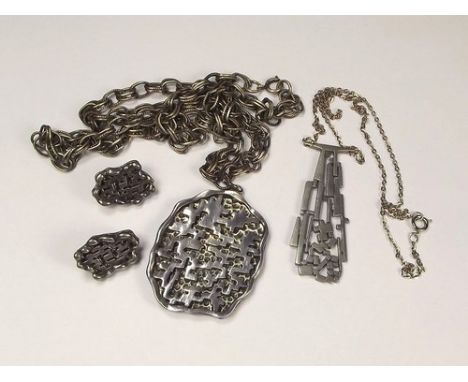 COSTUME JEWELLERY.
A sculptural pendant, 'Fantasy' by Ceard, Scotland & a Coro abstract pendant & matching ear clips.