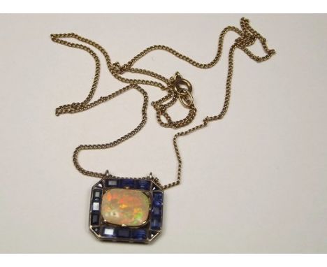 OPAL PENDANT.
A white metal mounted, opal & sapphire pendant, the cushion shaped opal of approx. 13 x 11mm, set within a bord