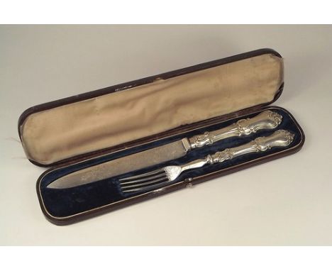 KNIFE & FORK SET.
A Victorian large knife & fork set, with filled silver handles, cased. Length of knife 28cm.