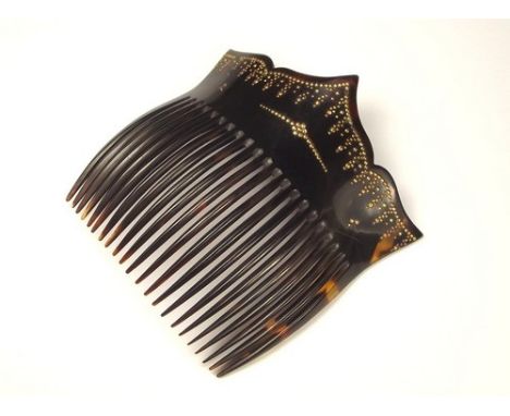 HAIR COMB.
A tortoiseshell & pique inlaid hair comb. Height 10cm.