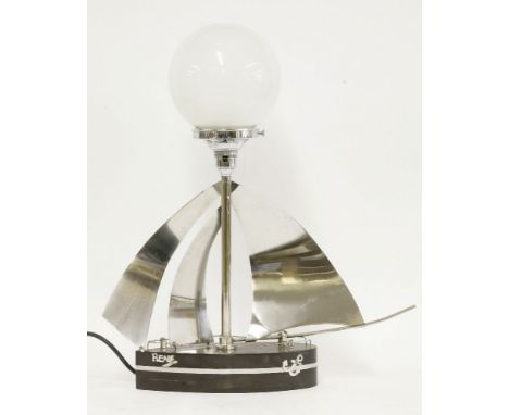 A desk lamp, in the form of the yacht 'Rene', with a Bakelite hull and chrome sails, rails, nameplate and anchor, fitted with