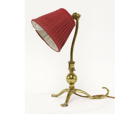An Arts and Crafts brass desk lamp,by W A S Benson, on a triform base, stamped 'Benson', with a modern shade,31cm high