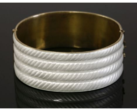 A Norwegian sterling silver gilt hinged bangle,by J Tostrup, with white guilloché enamel to four rope effect rows, 25mm wide,