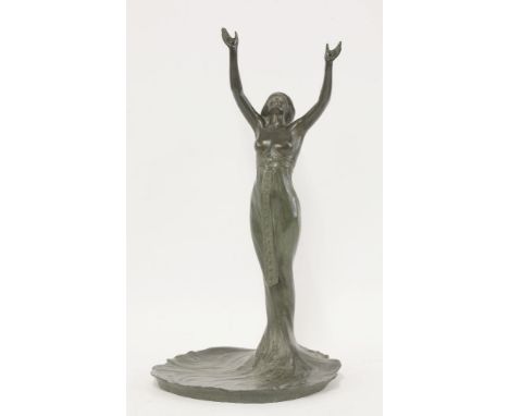 An Art Nouveau spelter lamp base,modelled as a lady with her arms aloft, baring her breasts in a sinuous dress forming the ba