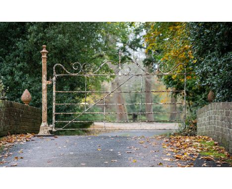A VICTORIAN WROUGHT IRON AND WHITE PAINTED GATE AND POST MID 19TH CENTURY the gate 145cm high, 243cm wide overall, the post 1