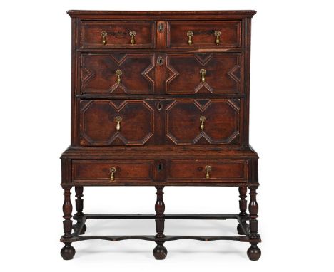 AN UNUSUAL SMALL OAK CHEST ON STAND  CIRCA 1690-1710 With an arrangement of mitre-moulded drawer fronts 122cm high, 95cm wide