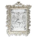 A LARGE CONTINENTAL CARVED WOOD AND WHITE PAINTED MIRROR, 18TH CENTURY AND LATER