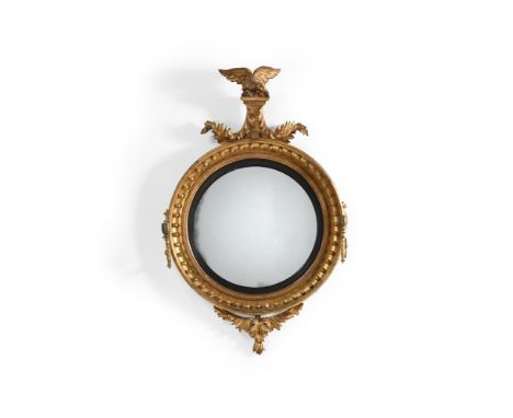 A GEORGE III CARVED GILTWOOD CONVEX GIRANDOLE MIRROR BY THOMAS FENTHAM, CIRCA 1800 Bearing maker's label to the reverse 115cm