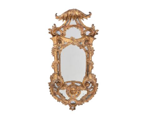 A CARVED GILTWOOD AND CARTON PIERRE MIRROR LATE 18TH OR EARLY 19TH CENTURY 145cm high, 75cm wide  The present lot draws inspi