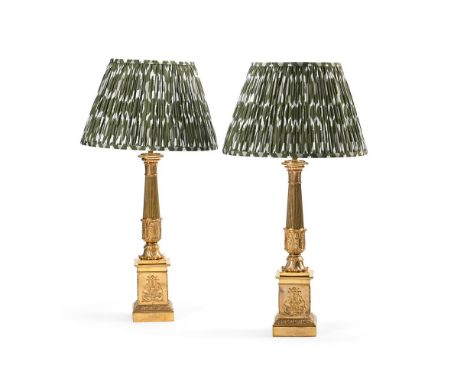 A PAIR OF FRENCH GILT METAL CARTEL LAMP BASES  EARLY 19TH CENTURY AND LATER FITTED Of columnar form, pedestal bases with appl