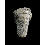 A LARGE CYPRIOT LIMESTONE HEAD OF A MALE DIGNITARY, LATE 6TH CENTURY B.C. OR EARLY 5TH CENTURY B.C.