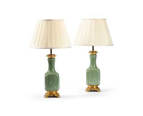 A PAIR OF CHINESE GREEN CELADON LAMP BASES  LATE 19TH CENTURY AND LATER FITTED  Of square bottle form, relief decoration of c