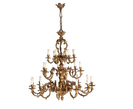 A LARGE GILT BRONZE TWENTY FOUR LIGHT CHANDELIER  IN 18TH CENTURY STYLE, 20TH CENTURY Open scrolling central stem supporting 