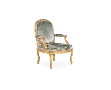 A LOUIS XV CARVED GILTWOOD ARMCHAIR BY LOUIS-CHARLES CARPENTIER, CIRCA 1765 The fauteuil a la Reine with ribbon tied twisted 