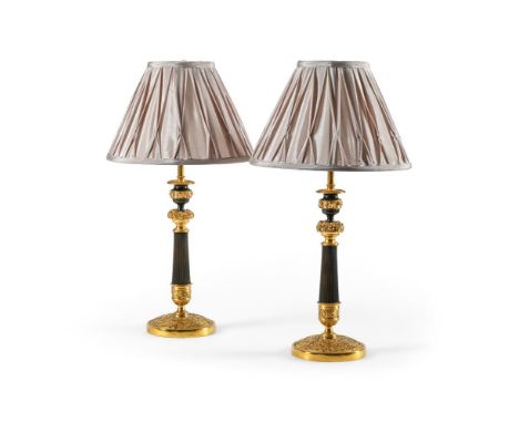 A PAIR OF FRENCH GILT AND PATINATED BRONZE CANDLESTICK LAMPS  EARLY 19TH CENTURY AND LATER  Now fitted as lamps with pair of 