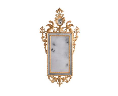 AN ITALIAN GILTWOOD AND COMPOSITION MIRROR LATE 18TH OR EARLY 19TH CENTURY With marginal plates, surmounted by a portrait eng