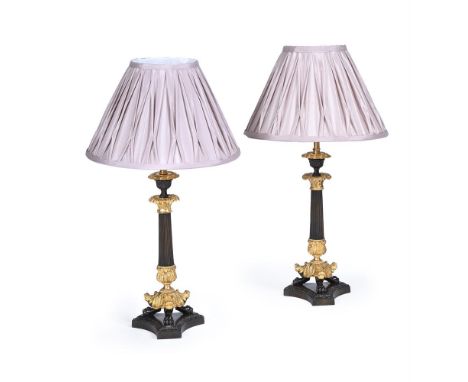 A PAIR OF FRENCH GILT AND PATINATED BRONZE LAMP BASES  SECOND HALF OF THE 19TH CENTURY AND LATER  Now wired, with pleated sha