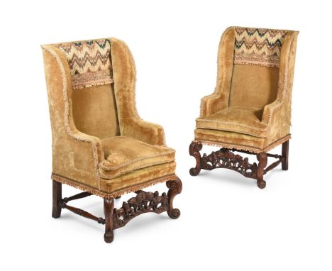 A PAIR OF CARVED WALNUT WING ARMCHAIRS CIRCA 1700 AND LATER Upholstered with fringed ochre velvet and sections of bargello em