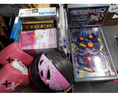 A good mixed lot to include a pair of Maxx Pro boxing gear storm gloves, pink, two bicycle helmets, a Hobbycraft mini sewing 