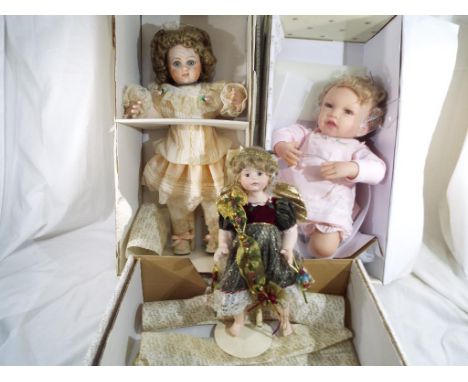 Two ceramic dressed Franklin Heirloom dolls, and one dressed doll by the Ashton-Drake Galleries