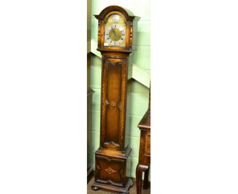 An early 20th century chiming small longcase clock, arch brass dial with silvered chapter ring, chiming on gong rods, signed 