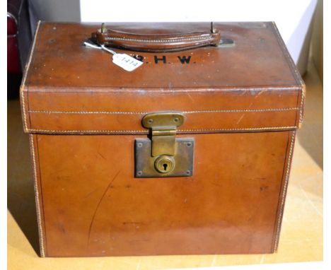 A vintage Finnigans leather top hat box, embossed with initials R.H.W, 35cm by 21cm, 28cm high, enclosing a grey Moss Bros. t