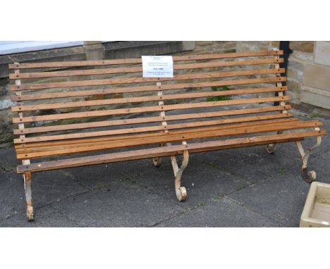 A Regency style metal garden bench with wooden slats 