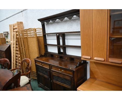 Antique oak dresser rack with spice drawers and two drawers above a pair of carved and panelled cupboard doors.  Height 194 c