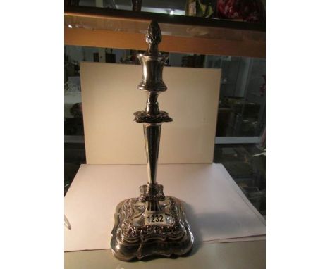 A silver plate candlestick with snuffer