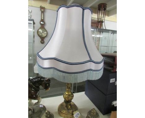 A gilded table lamp with shade
