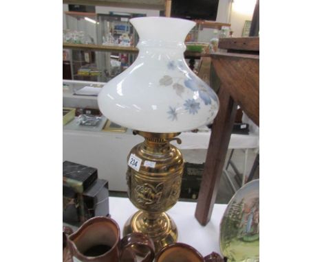 A brass oil lamp with shade