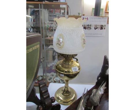A brass oil lamp with shade