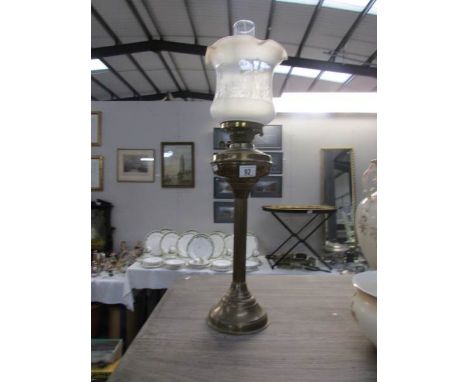 A brass oil lamp complete with shade and chimney