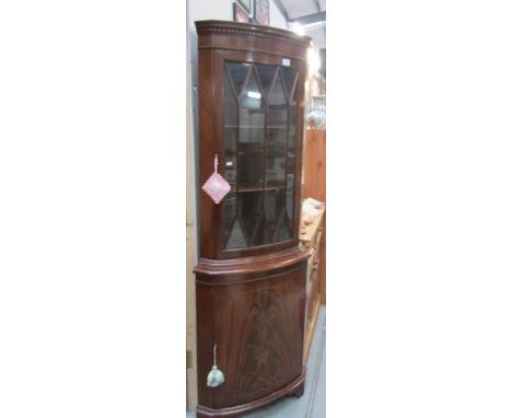 A mahogany glazed top corner cabinet