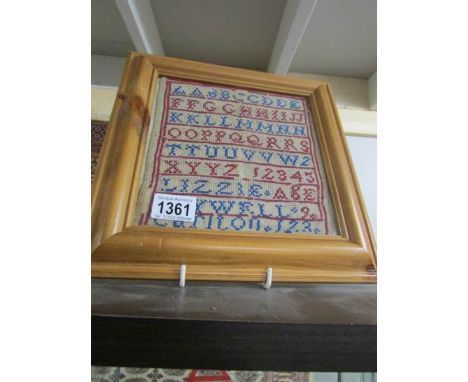 A framed and glazed sampler
