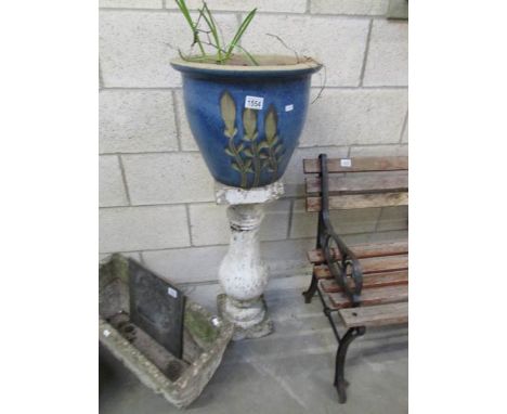 A ceramic planter on pedestal.