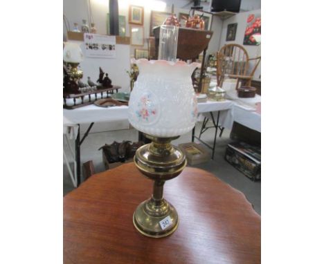A brass oil lamp with shade and chimney, shade a/f.