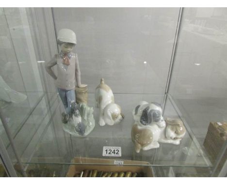 A NAO figure of a boy with dog, a group of 2 puppies and a puppy