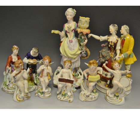 Continental ceramics - a set of Italian porcelain cherubs playing musical instruments; a 19th Century German figural group 'T