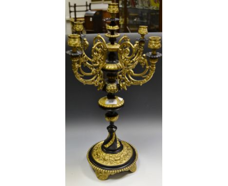 An early 20th century gilded metal centre piece four branch candleabrum, decorative supports terminating in griffin masks, st