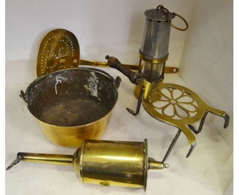 A George III brass trivet; a George Salter clockwork spit jack; a George III brass skillet; small brass pan; miners lamp (5)