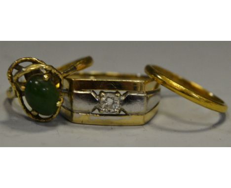 A 22ct gold narrow wedding band, 1.8g; a 22ct gold dress ring set with jade, gross weight 3.2g; a gold & white coloured gentl