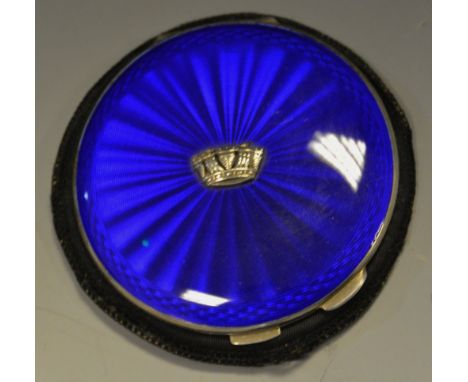 A silver compact with engine turned decoration and blue guilloche enamel, Birmingham 1975. 8cm diameter.