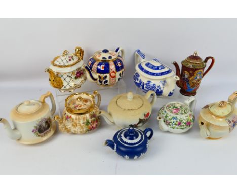 A collection of teapots to include a Spode Blue Tower pattern example, one with fox hunting decoration and other. [W]

NOTE: 