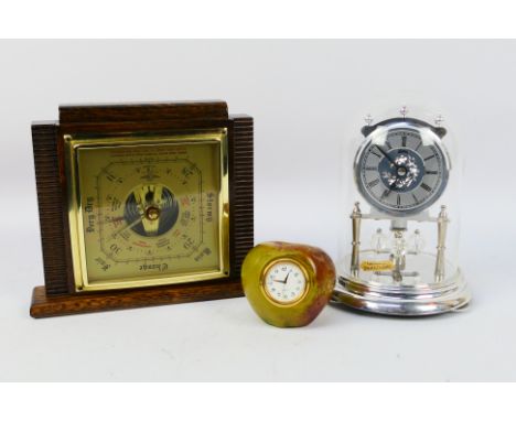 A Koma anniversary clock with Swarovski elements, desk clock in the form of an apple and a barometer. [W]