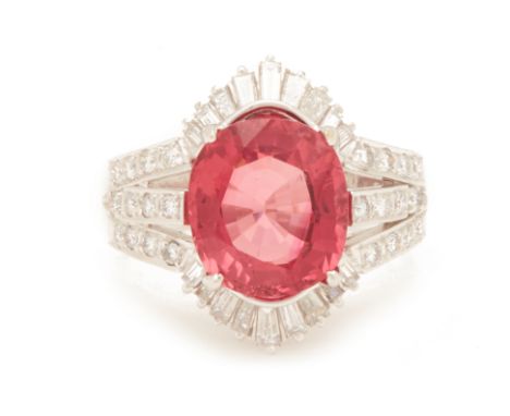 A PINK TOURMALINE AND DIAMOND CLUSTER RING
Set in 18k white gold, the oval cut pink tourmaline, within a surround of tapered 