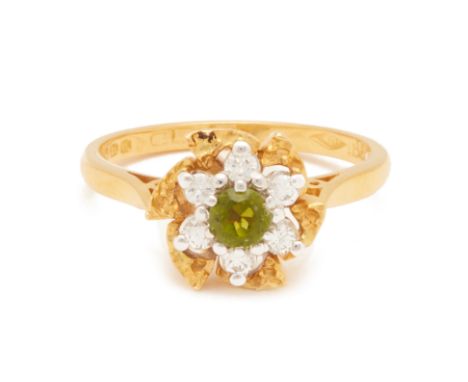 A TOURMALINE AND DIAMOND FLOWERHEAD CLUSTER RING
Set in 18k yellow and white gold, the central tourmaline set within a surrou