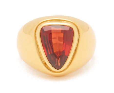 A RED GARNET SINGLE STONE RING
Set in 18k yellow gold, the triangular shaped garnet bezel set in a thick gold band
US ring si