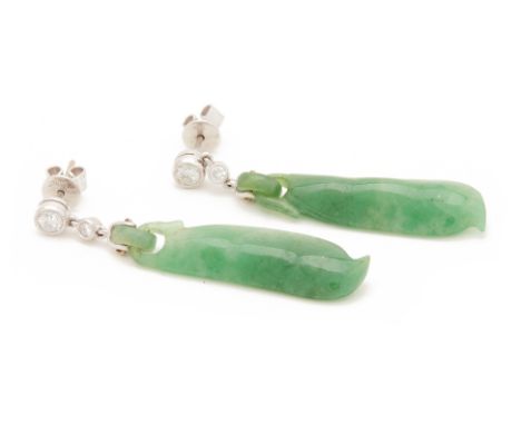 A PAIR OF CARVED JADE AND DIAMOND EARRINGS
In 18k gold, set with two round brilliant cut diamonds above a carved jade drop mo